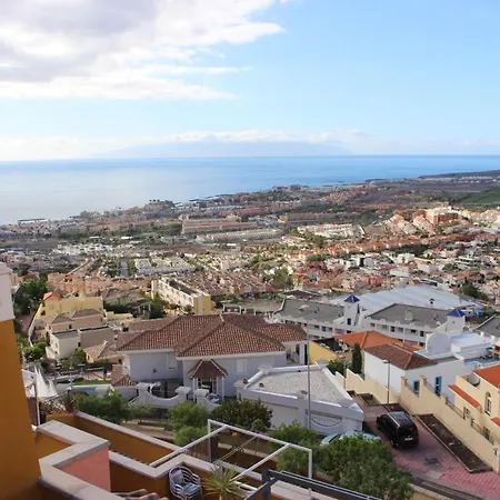 With A Serene Ocean And Mountain View أذيخي